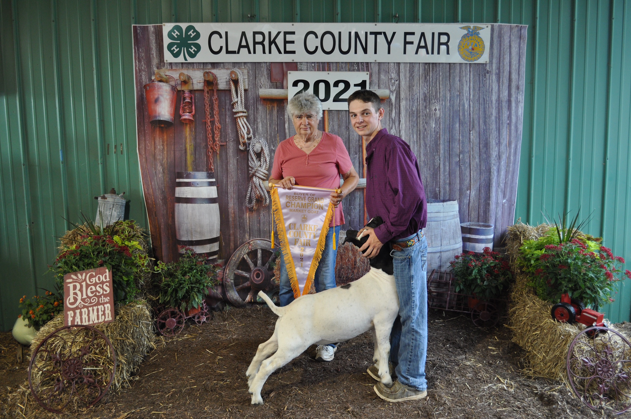 a boy shows his winning goat