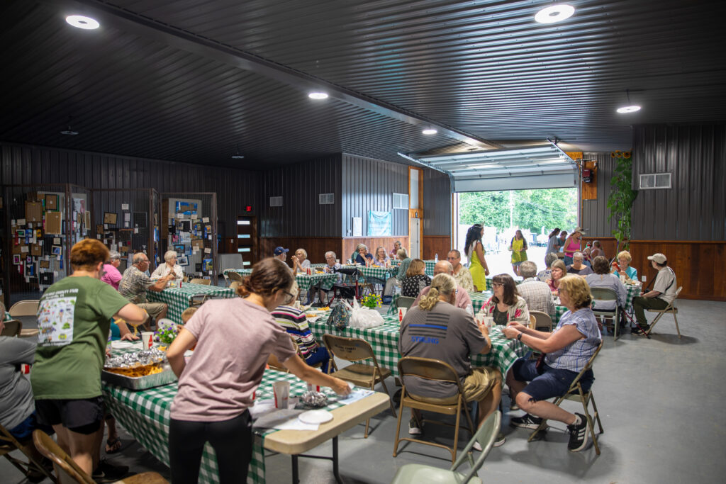 People enjoying a luncheon in the renovated Horticulture building.